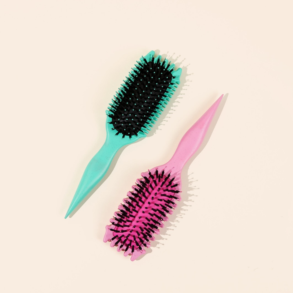 Bounce curl brush naast een teal kleurige brush